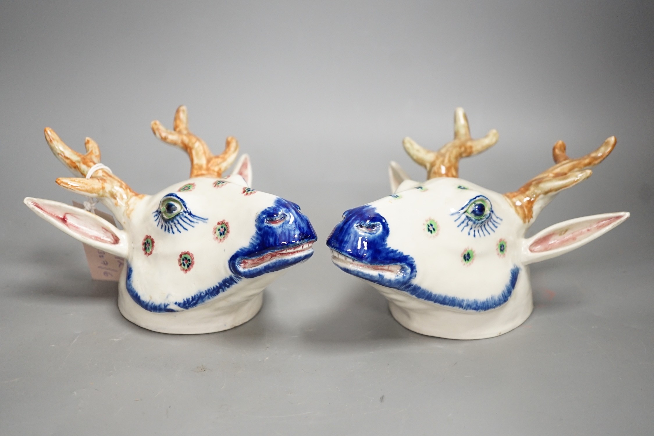 Two Continental pottery stag head wall pockets, 22cms high